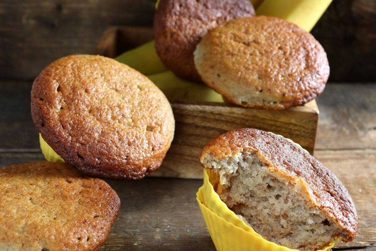 Muffins de banana e aveia com um deles partido ao meio mostrando a textura
