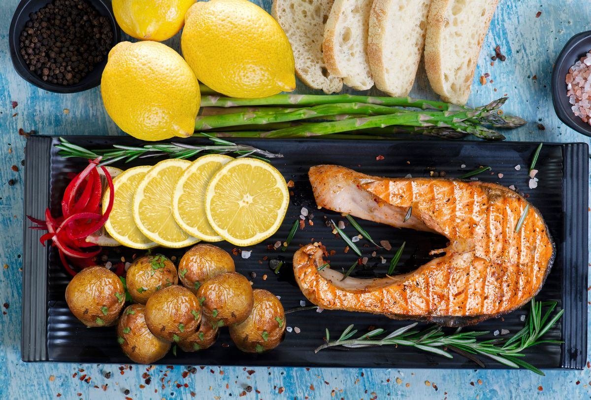 Posta de salmão assado com aspargos, batatas e limão